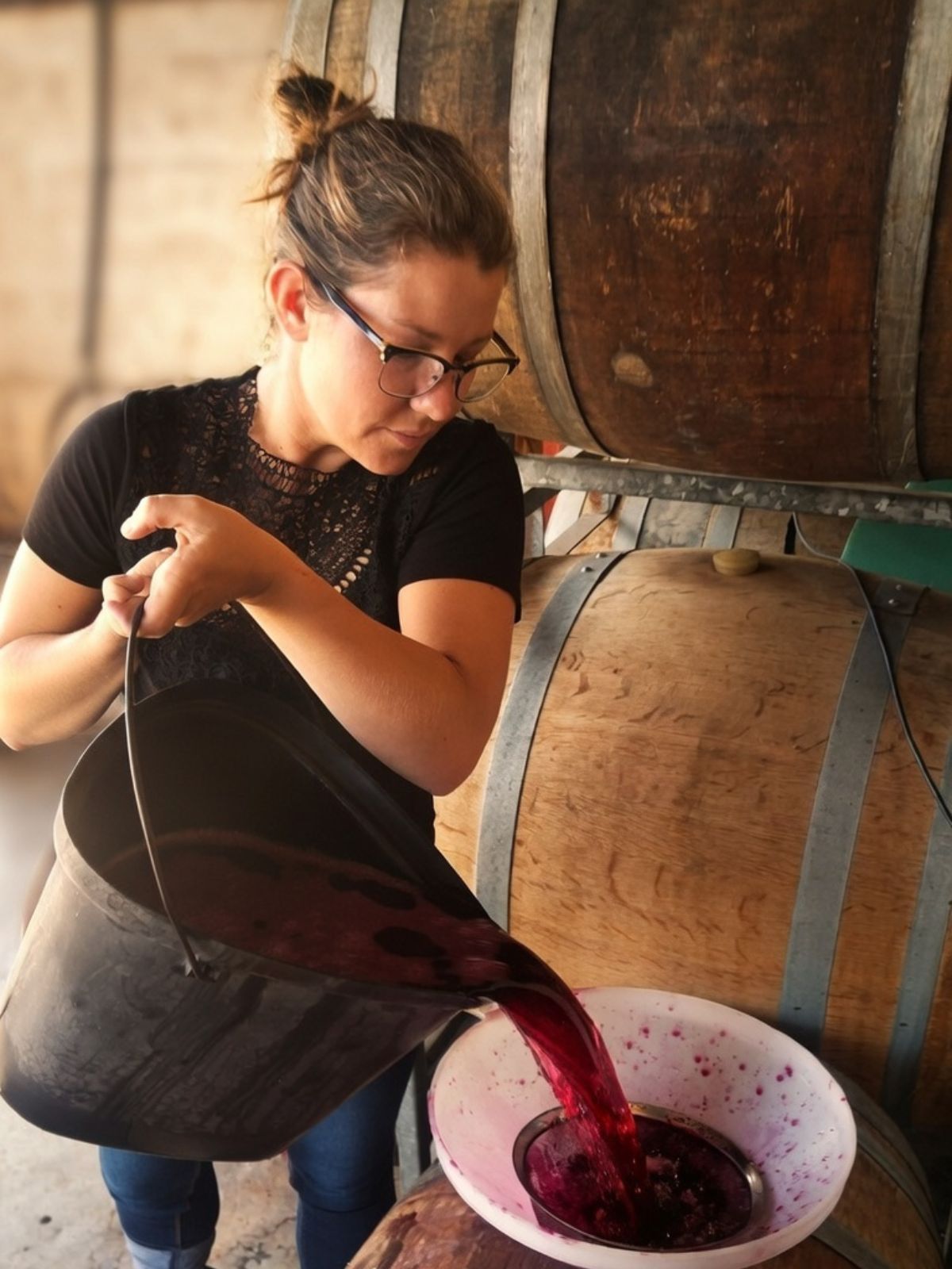 Pouring red must during barrel filling